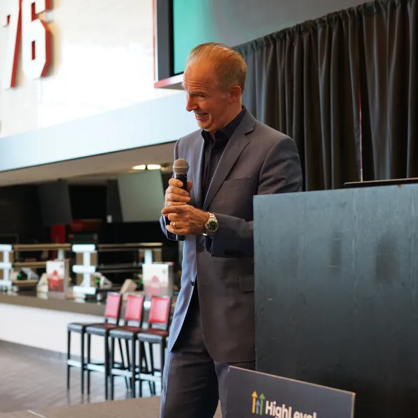 David Lee Jensen sharing a candid moment on stage under neon lights